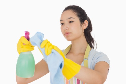 Cleaner using professional carpet cleaning equipment with attention to safety