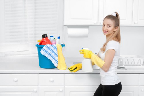 Cleaner managing hoses and cables safely during a carpet cleaning job
